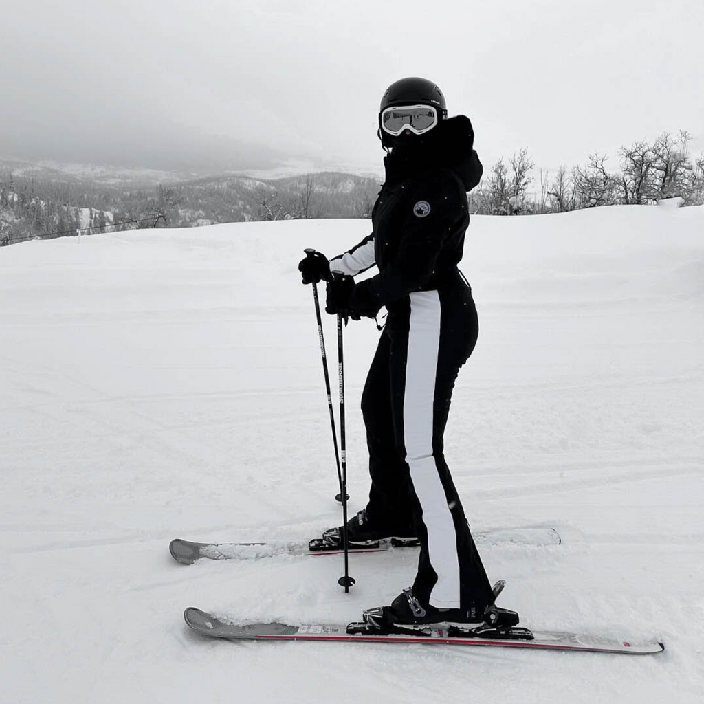 Les Odettes women's classic faux fur one-piece ski suit, insulated winter ski outfit with hood and full-length zipper.