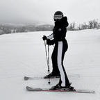 Les Odettes women's classic faux fur one-piece ski suit, insulated winter ski outfit with hood and full-length zipper.