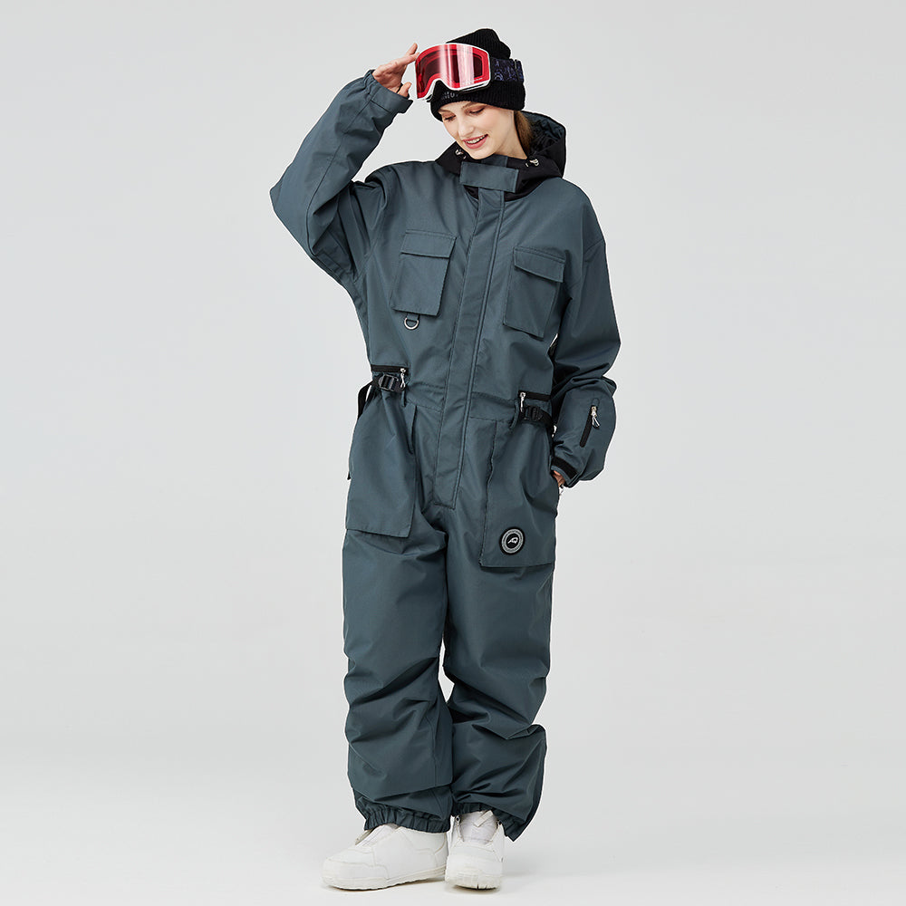 Les Odettes Women's Arctic Queen IceStorm mountain adventure one-piece snowsuit in white with hood and winter insulation.