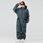 Les Odettes Women's Arctic Queen IceStorm mountain adventure one-piece snowsuit in white with hood and winter insulation.
