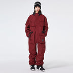 Women's Arctic Queen IceStorm mountain adventure one-piece snowsuit by Les Odettes, shown in a winter outdoor setting.