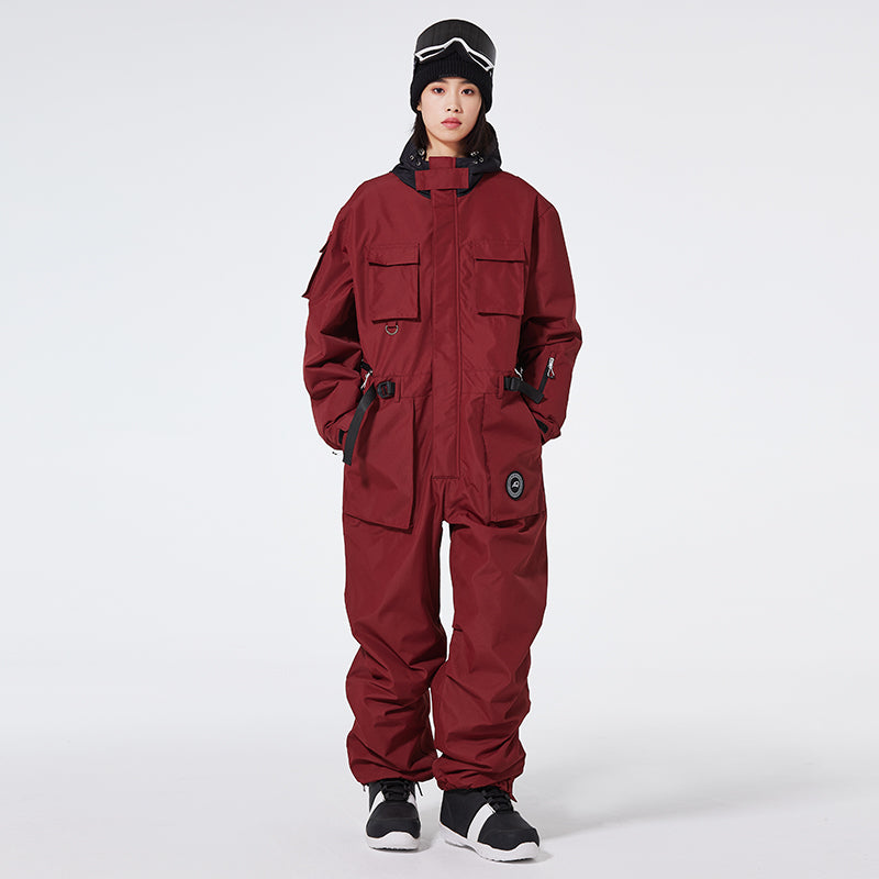 Women's Arctic Queen IceStorm mountain adventure one-piece snowsuit by Les Odettes, shown in a winter outdoor setting.