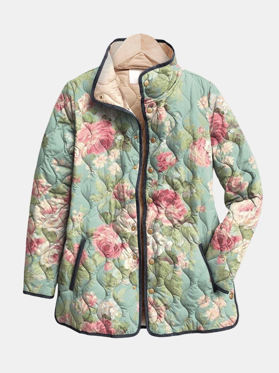 Les Odettes Evie™ retro quilted jacket in pastel pink with a classic quilted pattern and collar, displayed on a hanger.