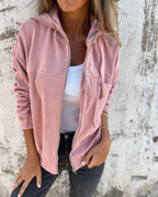 Les Odettes Cynthia™ hooded zip jacket, front view showing the black jacket with a hood, full zip closure, and casual style.