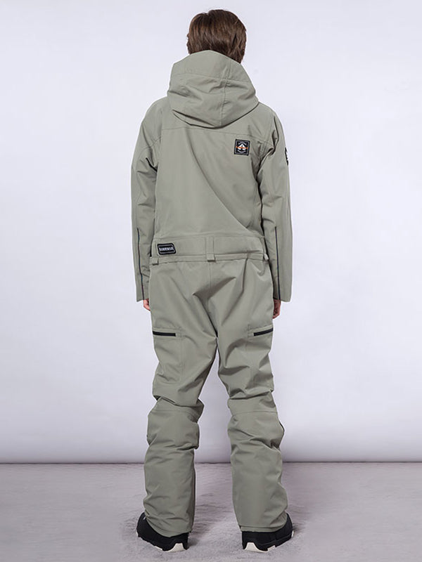 Les Odettes men's RAWRWAR high land cargo one-piece snowsuit displayed on model with rugged winter design and multiple cargo pockets.