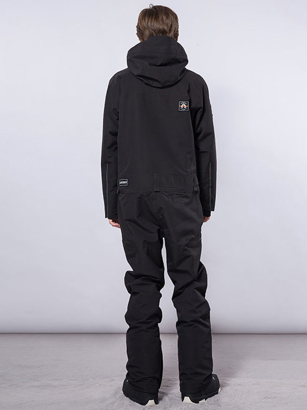 Men's RAWRWAR high land cargo one-piece snowsuit by Les Odettes, showing the durable winter snowsuit with cargo pockets and hood.