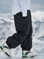 Men's Rabbit Snow StreetFlow Freestyle Cargo Baggy Snow Pants by Les Odettes, showing their relaxed fit and snow-resistant fabric.
