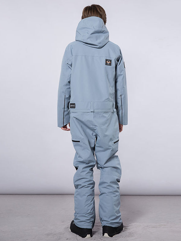 Men's Les Odettes RAWRWAR high land cargo one-piece snowsuit with hood, featuring multiple cargo pockets and durable winter fabric.