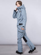 Men's RAWRWAR highland cargo one-piece snowsuit by Les Odettes, shown in a winter outdoor setting with insulated design.