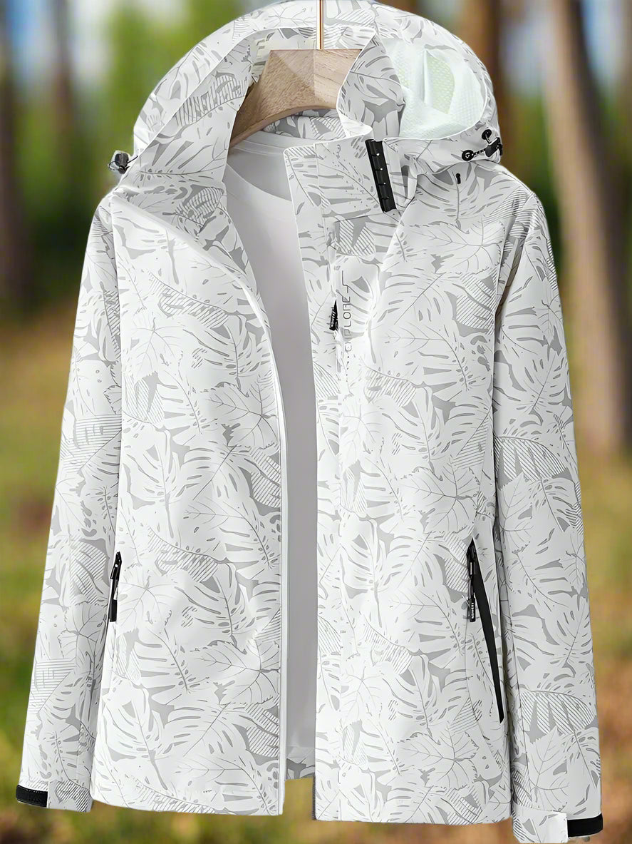 Les Odettes Leslie women's waterproof summer jacket in lightweight fabric, shown in a stylish navy color with a hood and zip closure.