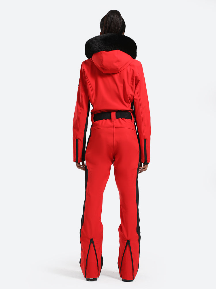 Les Odettes women's classic faux fur one-piece ski suit, featuring a stylish ski outfit with a fur-lined hood and winter insulation.