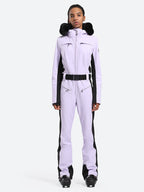 Les Odettes women's classic faux fur one-piece ski suit with a hood, designed for warmth and style on the slopes.