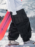 Men's Les Odettes Snow Prime Cargo snowboard pants in black, baggy style with multiple pockets and snow-resistant fabric.