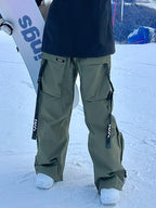 Men's snow pants by Les Odettes, Keep Money Mountain Chill Baggy snow pants with a relaxed fit, shown in black fabric with snow details.