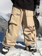 Les Odettes men's snow pants with a baggy fit, mountain chill design, black color, and adjustable waistband for winter snowboarding.