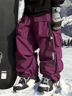 Les Odettes men's snow pants with baggy fit and mountain-inspired design, suitable for winter snowboarding or skiing.