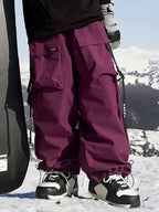 Les Odettes men's snow pants, Keep Money Mountain Chill Baggy style, with black waterproof fabric and adjustable waistband.