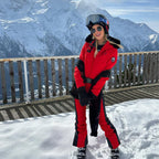 Les Odettes women's classic faux fur one-piece ski suit with hood, designed for warmth and style on the slopes.