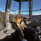 Les Odettes women's classic faux fur one-piece ski suit with hood, designed for warmth and style on the slopes.