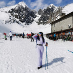 Les Odettes women's classic faux fur one-piece ski suit with a sleek design and cozy fur trim, ideal for winter sports.