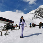 Les Odettes women's classic faux fur one-piece ski suit with hood, waterproof fabric, and insulated design for winter skiing.