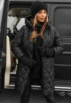 Les Odettes Riley™ quilted coat on a hanger, featuring a stylish padded design and sleek quilting details.
