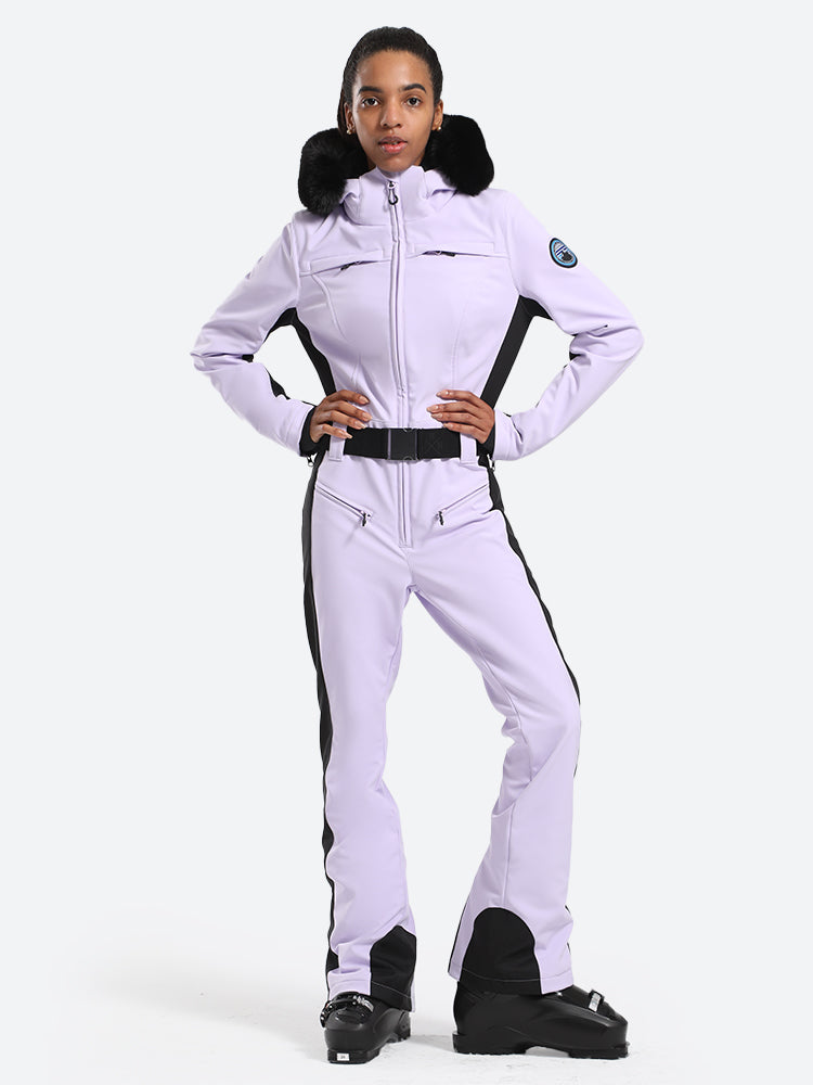 Les Odettes women's classic faux fur one-piece ski suit, featuring a stylish ski outfit with fur-lined collar and sleek design.