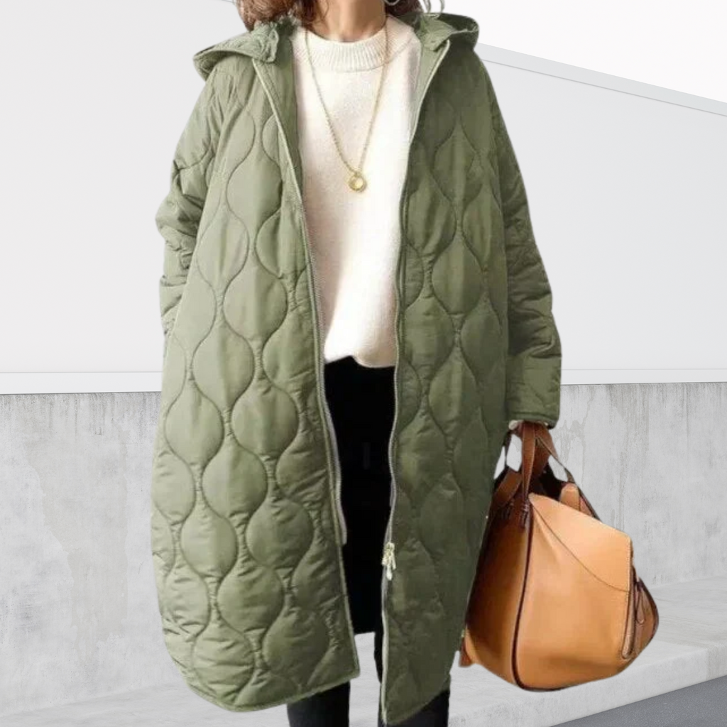 Les Odettes Nordica oversized hooded parka with detailed design, showcasing a warm coat with a large hood and stylish features.