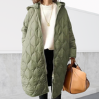 Les Odettes Nordica oversized hooded parka with detailed design, showcasing a warm coat with a large hood and stylish features.