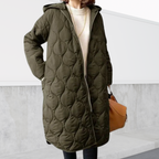 Les Odettes Nordica oversized hooded parka with detailed stitching and cozy design, perfect for cold weather.