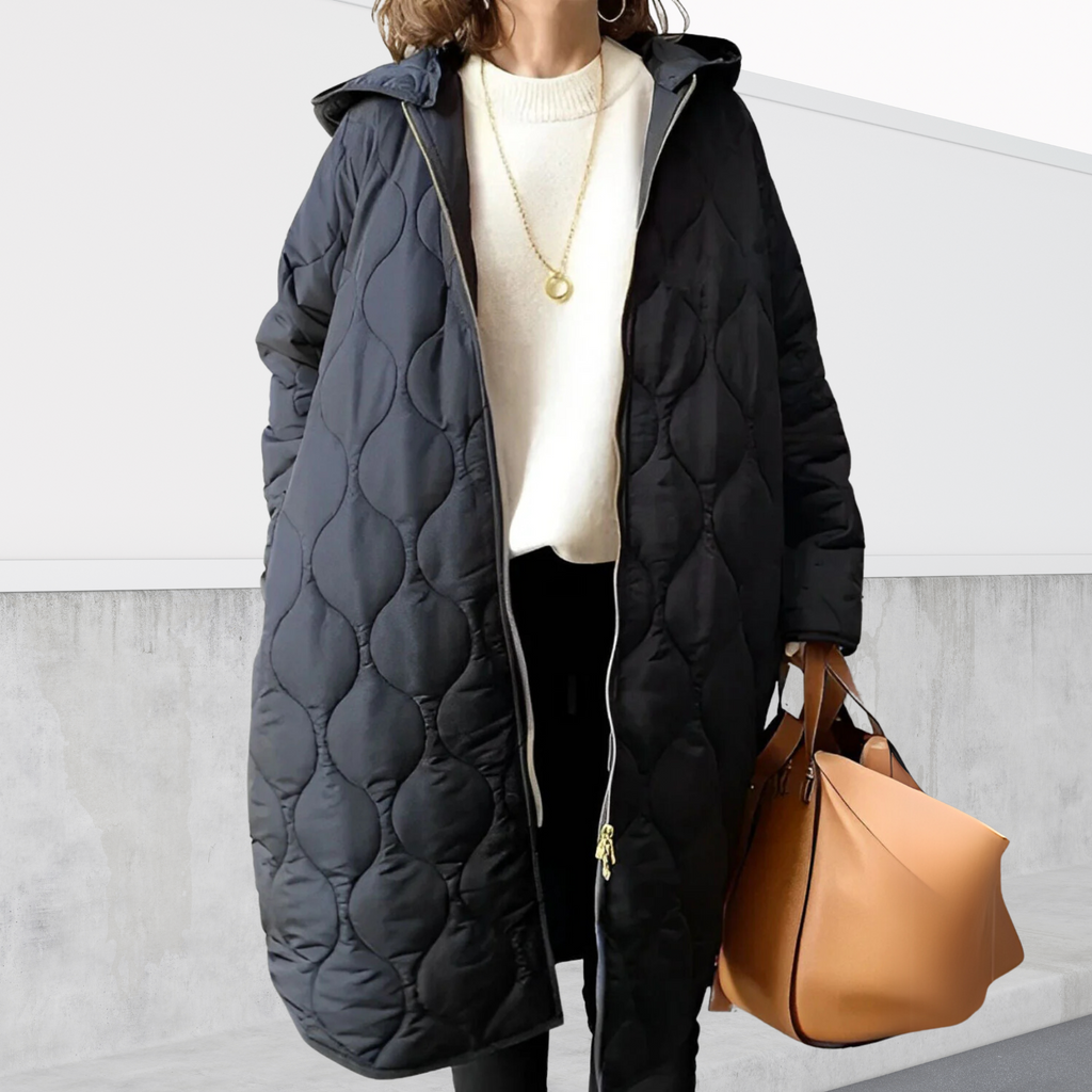 Les Odettes Nordica oversized hooded parka with detailed design, featuring a large hood and stylish coat silhouette.
