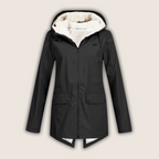 Les Odettes ThermaShell™ windproof and waterproof rain jacket in dark color, showing its lightweight, durable outdoor coat design.