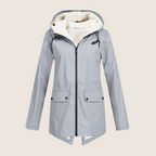 Les Odettes ThermaShell windproof and waterproof rain jacket, shown in bright blue with a hood and adjustable cuffs.