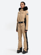Les Odettes women's classic faux fur one-piece ski suit with hood and waterproof design, perfect for winter outdoor skiing activities.