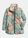 Les Odettes Eliza™ quilted floral print jacket with textured quilting and vibrant flower patterns, displayed on a hanger.