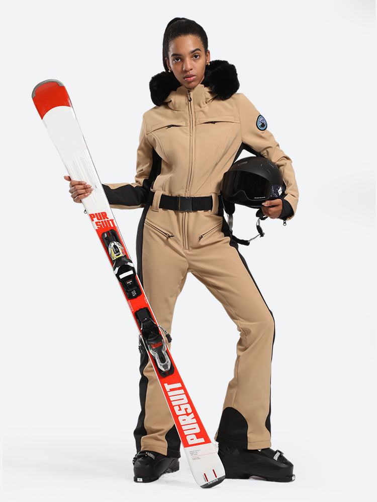 Les Odettes women's classic faux fur one-piece ski suit with hood and zipper for stylish winter skiing.
