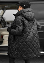 Les Odettes Riley™ quilted coat in a stylish padded design, shown in a close-up of the textured, quilted fabric.