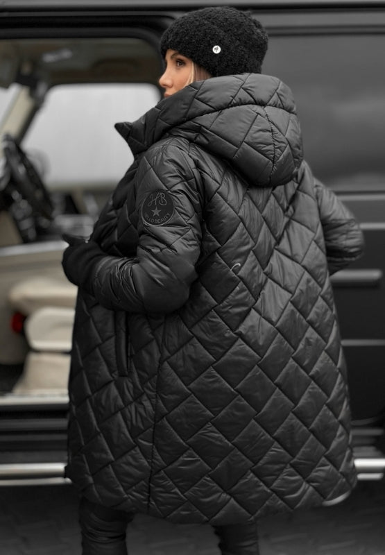 Les Odettes Riley™ quilted coat in a stylish padded design, shown in a close-up of the textured, quilted fabric.
