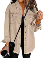 Les Odettes Gabriella™ denim jacket displayed on a hanger, featuring classic blue denim with button front and collar.