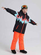 Boy and girl wearing Les Odettes Phibee Lightning Duck Down snow jackets, kids' winter snow jackets, outdoors in snowy setting.