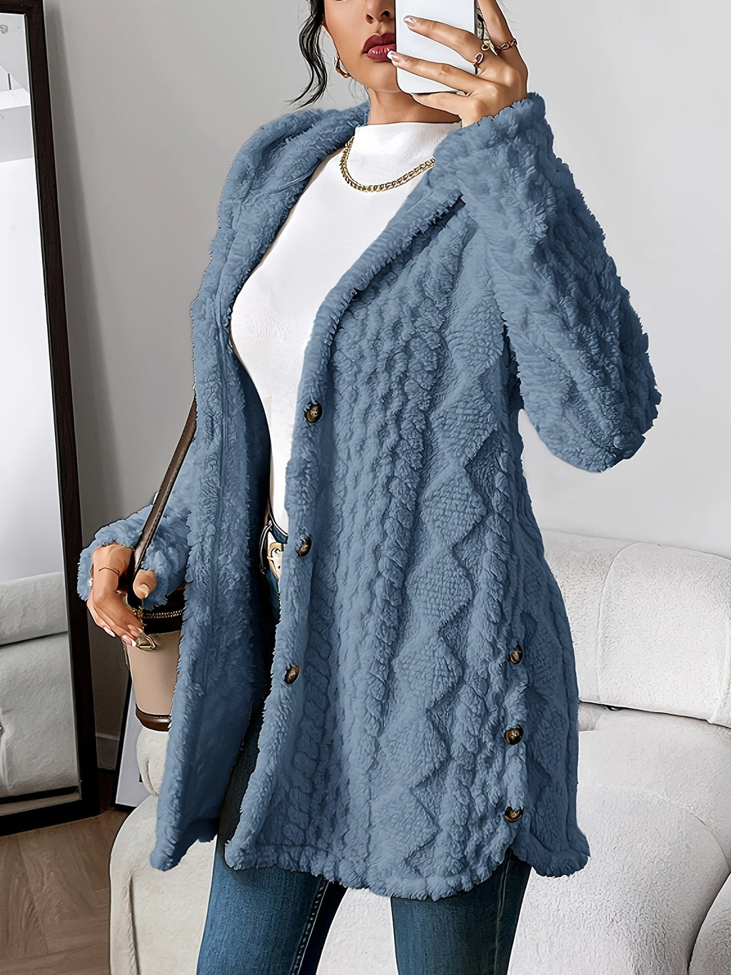 Les Odettes Adriana™ plush hooded cardigan with soft fabric, displayed on a hanger, featuring a cozy hood and relaxed fit.