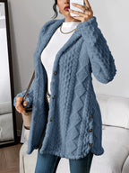 Les Odettes Adriana™ plush hooded cardigan with soft fabric, displayed on a hanger, featuring a cozy hood and relaxed fit.