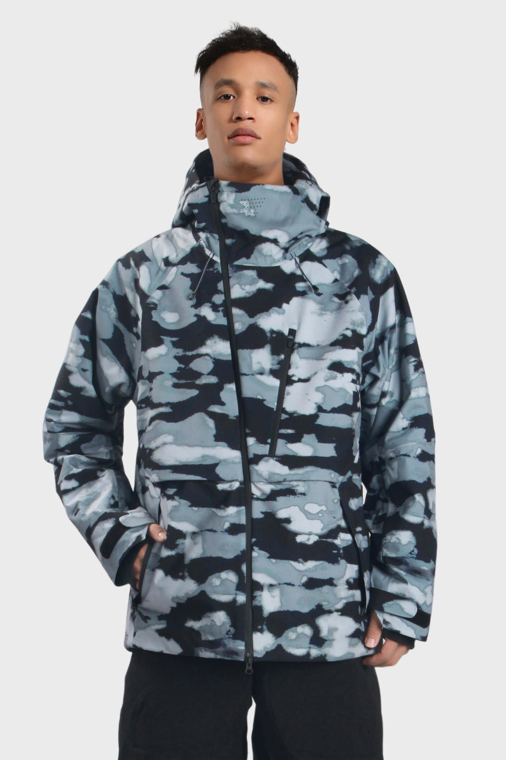 Men's camouflage snow jacket by Les Odettes with face vent, multiple pockets, fully waterproof, and suitable for winter outdoor activities.