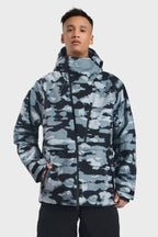 Men's camouflage snow jacket by Les Odettes with face vent, multiple pockets, fully waterproof, and suitable for winter outdoor activities.