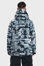 Men's camouflage snow jacket by Les Odettes with face vent, multiple pockets, and waterproof design for winter outdoor wear.