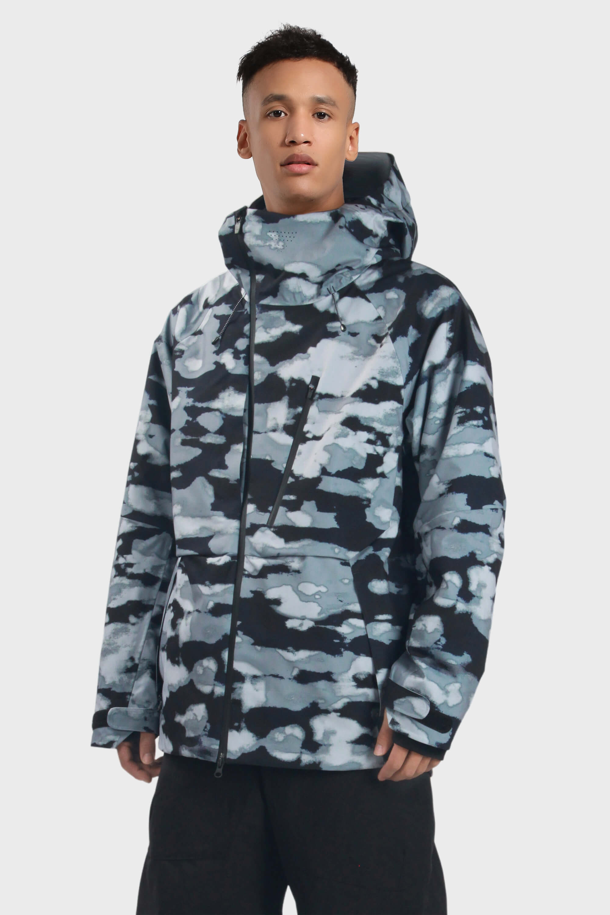 Men's camouflage snow jacket by Les Odettes featuring face vent, multiple pockets, and fully waterproof design for winter outdoor activities.