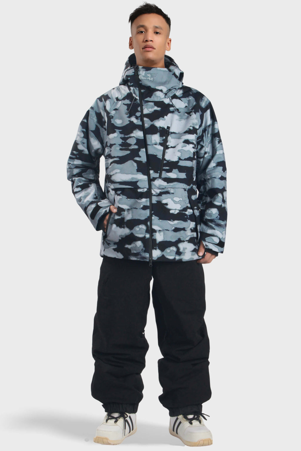 Men's camouflage snow jacket by Les Odettes with face vent, multiple pockets, and fully waterproof design for winter outdoor activities.