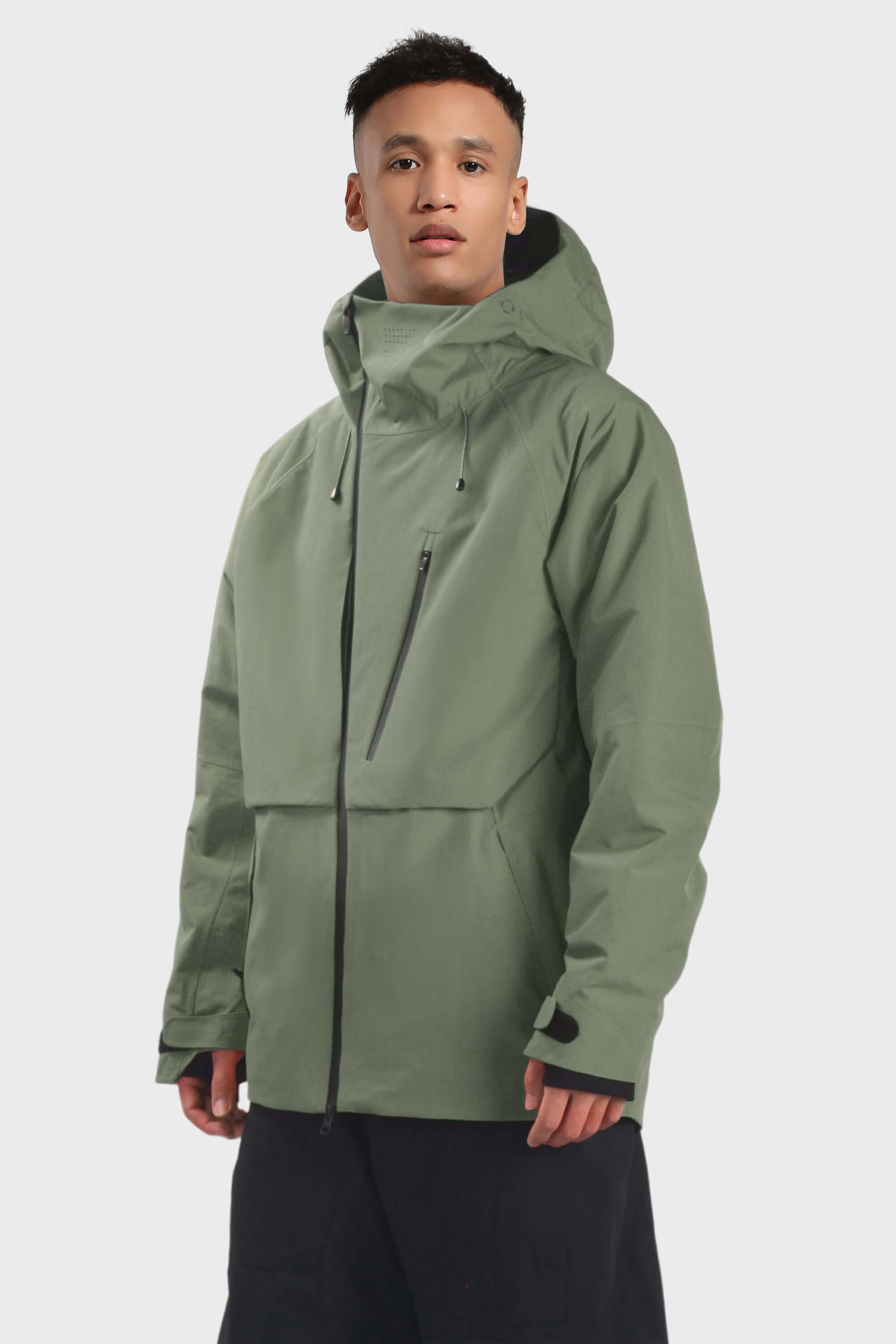 Men's camouflage snow jacket by Les Odettes with face vent, multiple pockets, and waterproof design, shown with a front view.