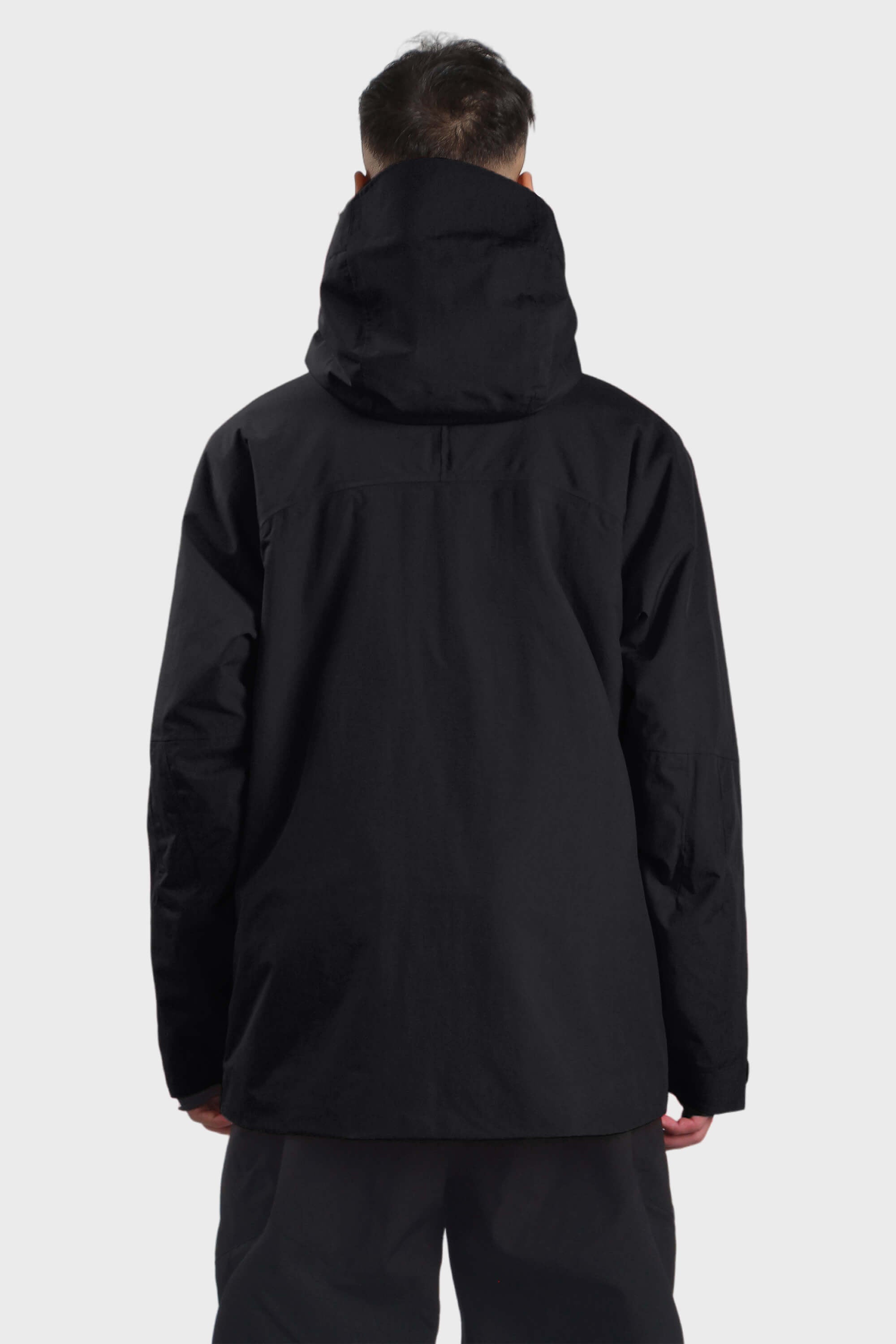 Men's camouflage snow jacket by Les Odettes featuring face vent, multiple pockets, and waterproof design in black.