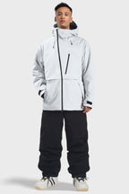 Men's camouflage snow jacket by Les Odettes with face vent, multiple pockets, fully waterproof, and insulated for winter outdoor activities.